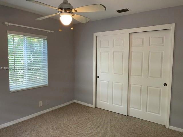 5433 NE 5th Ave, Oakland Park, FL 33334 - unfurnished bedroom with carpet floors, a closet, and ceiling fan