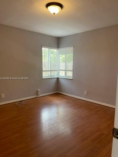 5433 NE 5th Ave, Oakland Park, FL 33334 - unfurnished room with wood finished floors and baseboards