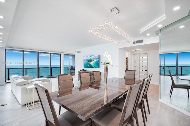 9455 Collins Ave Unit 809, Surfside, FL 33154 - dining area featuring a wall of windows, recessed lighting, and light wood-style floors