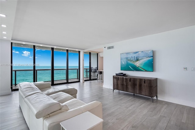 9455 Collins Ave Unit 809, Surfside, FL 33154 - living area with expansive windows, wood finished floors, and recessed lighting