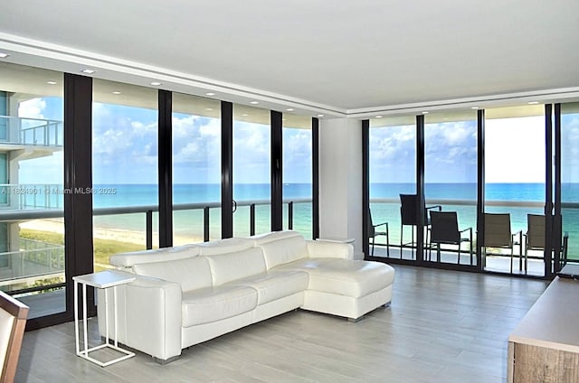 9455 Collins Ave Unit 809, Surfside, FL 33154 - living area with a wall of windows, healthy amount of natural light, a water view, wood finished floors, and recessed lighting