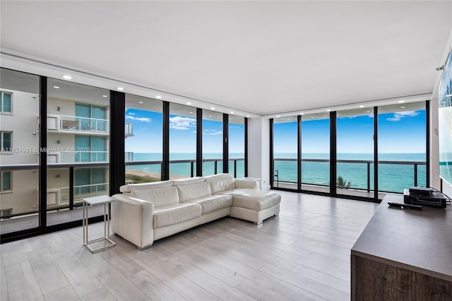 9455 Collins Ave Unit 809, Surfside, FL 33154 - living room with a wall of windows, a water view, and light wood finished floors
