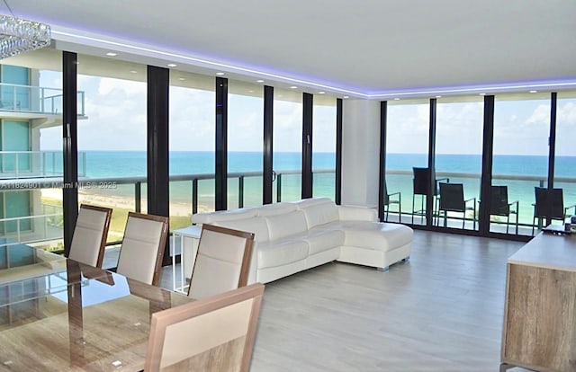 9455 Collins Ave Unit 809, Surfside, FL 33154 - living room featuring a wall of windows, a water view, wood finished floors, and recessed lighting