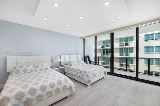 9455 Collins Ave Unit 809, Surfside, FL 33154 - bedroom featuring a wall of windows, wood finished floors, and recessed lighting
