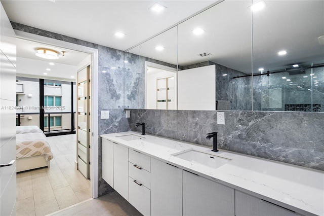 9455 Collins Ave Unit 809, Surfside, FL 33154 - full bath featuring connected bathroom, double vanity, a shower stall, tile patterned floors, and recessed lighting