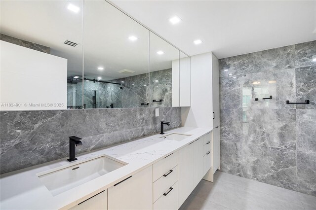 9455 Collins Ave Unit 809, Surfside, FL 33154 - full bathroom featuring a marble finish shower, double vanity, tasteful backsplash, and recessed lighting