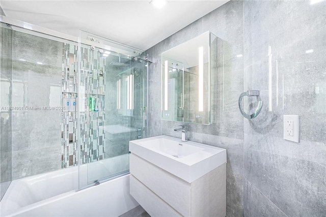 9455 Collins Ave Unit 809, Surfside, FL 33154 - bathroom featuring bath / shower combo with glass door, tile walls, and vanity
