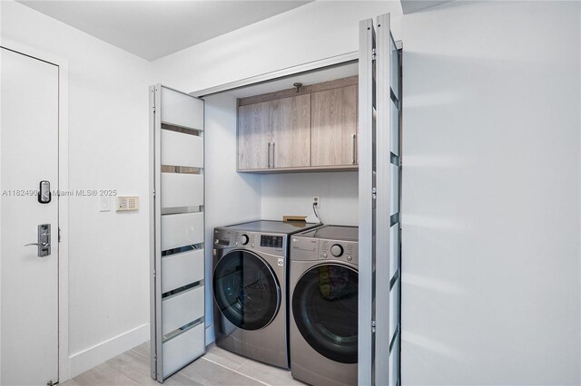 9455 Collins Ave Unit 809, Surfside, FL 33154 - washroom featuring washer and clothes dryer and cabinet space