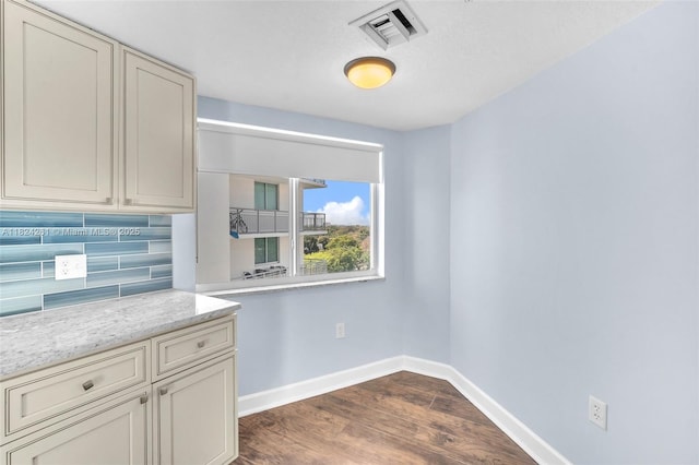 280 SW 20th Rd Unit 904, Miami, FL 33129 - kitchen featuring backsplash, dark wood-style flooring, and light stone countertops