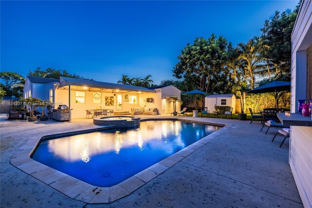 433 NE 91st St, Miami Shores, FL 33138 - view of pool featuring a patio area, a storage unit, and a pool with connected hot tub