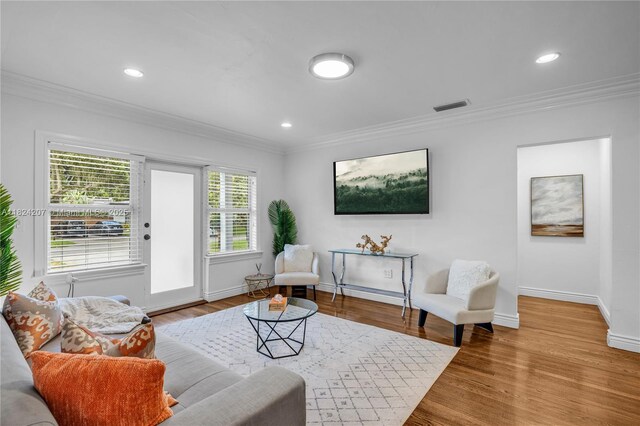 433 NE 91st St, Miami Shores, FL 33138 - living area with crown molding, wood finished floors, and recessed lighting