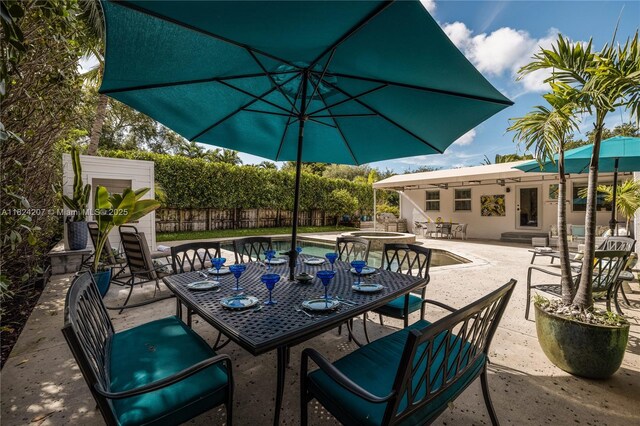 433 NE 91st St, Miami Shores, FL 33138 - view of patio with outdoor dining area and a pool with connected hot tub