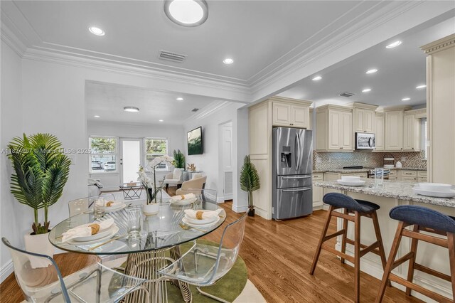 433 NE 91st St, Miami Shores, FL 33138 - dining space with light wood-type flooring, crown molding, and recessed lighting