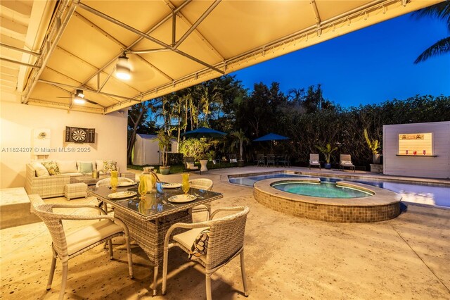 433 NE 91st St, Miami Shores, FL 33138 - view of patio with a pool with connected hot tub, outdoor dining area, and a shed