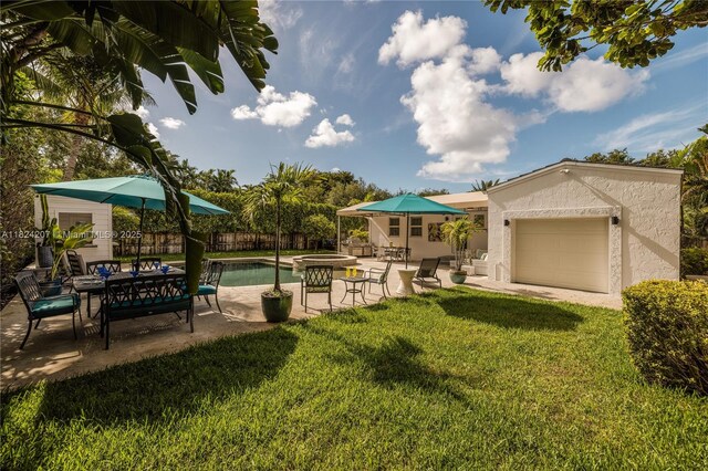 433 NE 91st St, Miami Shores, FL 33138 - view of yard featuring a patio area and an attached garage