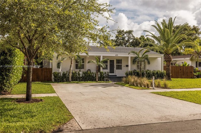 433 NE 91st St, Miami Shores, FL 33138 - view of front of house featuring a porch, stucco siding, and driveway