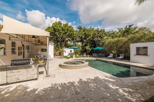 433 NE 91st St, Miami Shores, FL 33138 - view of pool with a patio, exterior kitchen, and a pool with connected hot tub