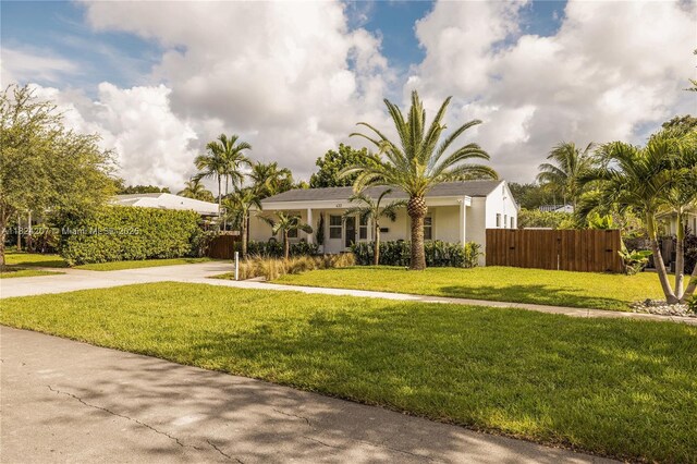 433 NE 91st St, Miami Shores, FL 33138 - view of property hidden behind natural elements featuring concrete driveway and stucco siding