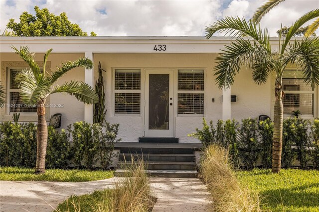 433 NE 91st St, Miami Shores, FL 33138 - view of exterior entry featuring stucco siding