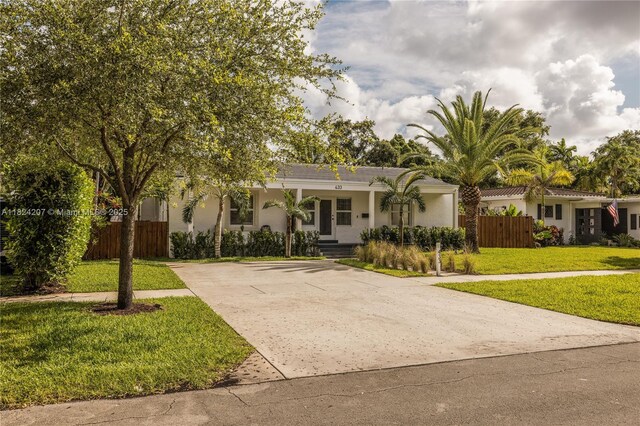 433 NE 91st St, Miami Shores, FL 33138 - view of front facade with driveway, a porch, and stucco siding