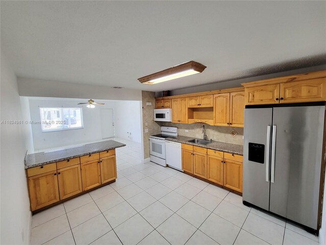1800 SW 97th Ave, Miramar, FL 33025 - kitchen featuring white appliances, dark stone countertops, light tile patterned floors, a ceiling fan, and tasteful backsplash