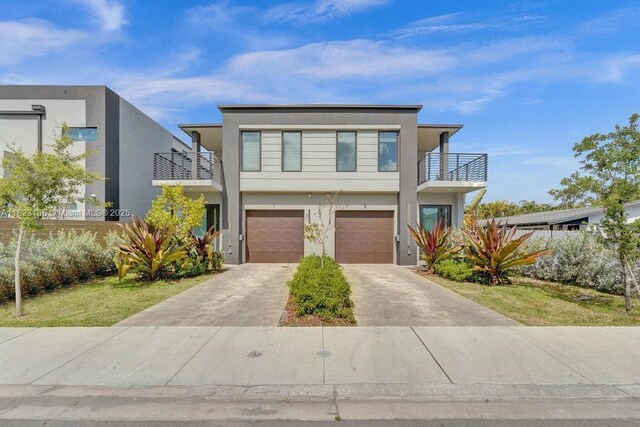 1101 NE 16th Ter Unit 1, Fort Lauderdale, FL 33304 - contemporary house with a balcony, driveway, stucco siding, and a garage