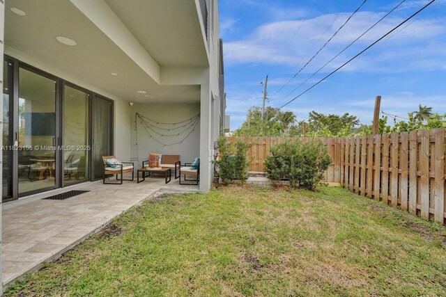 1101 NE 16th Ter Unit 1, Fort Lauderdale, FL 33304 - fenced backyard featuring an outdoor hangout area and a patio area