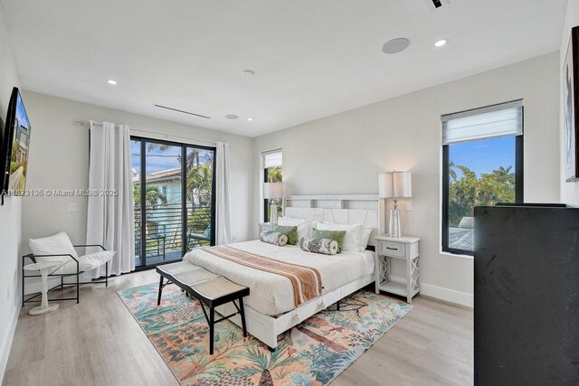 1101 NE 16th Ter Unit 1, Fort Lauderdale, FL 33304 - bedroom with multiple windows, light wood-type flooring, access to outside, and recessed lighting