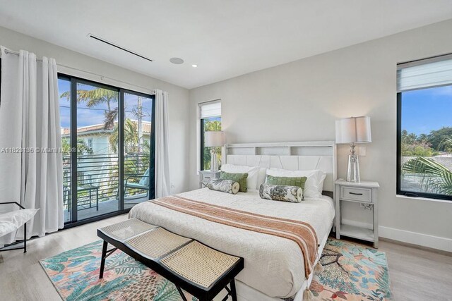1101 NE 16th Ter Unit 1, Fort Lauderdale, FL 33304 - bedroom featuring access to exterior, light wood-type flooring, and recessed lighting