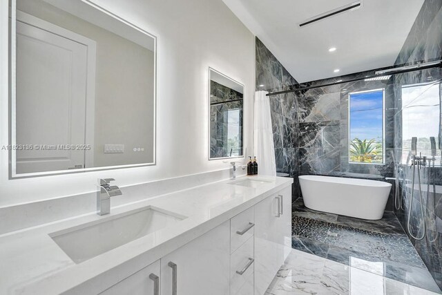 1101 NE 16th Ter Unit 1, Fort Lauderdale, FL 33304 - bathroom featuring marble tiled floors, a freestanding tub, double vanity, recessed lighting, and a shower with shower curtain