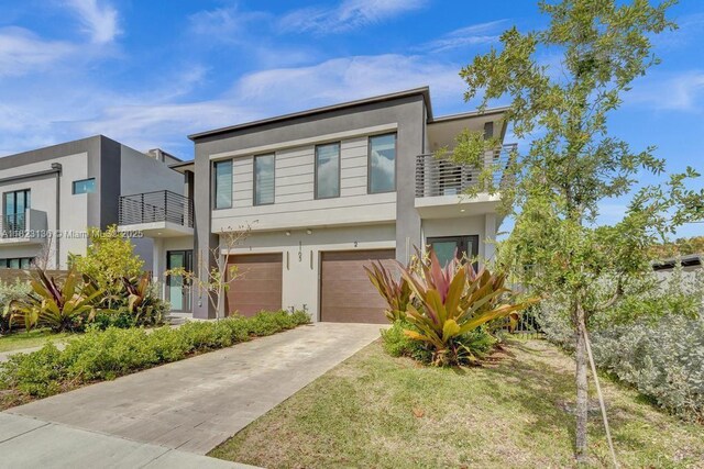 1101 NE 16th Ter Unit 1, Fort Lauderdale, FL 33304 - contemporary home with concrete driveway, stucco siding, a balcony, and a garage