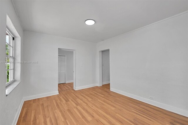 1355 NW 121st St, North Miami, FL 33167 - empty room featuring light wood-style flooring and baseboards