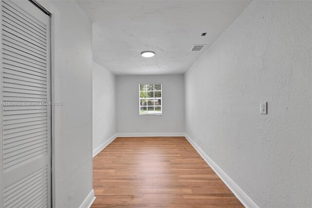 1355 NW 121st St, North Miami, FL 33167 - empty room featuring wood finished floors and a textured wall