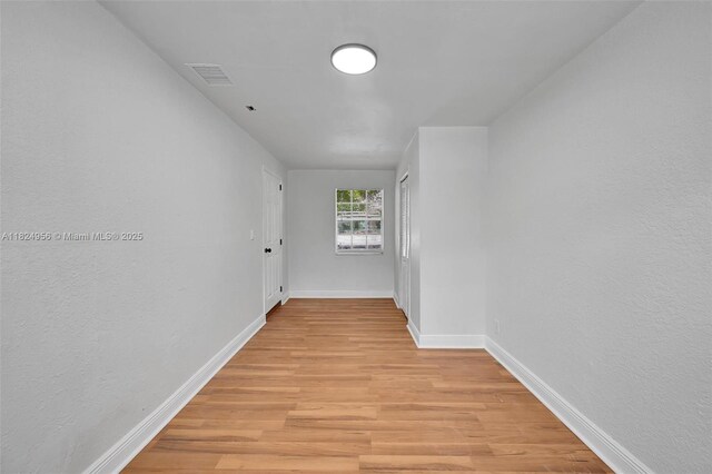 1355 NW 121st St, North Miami, FL 33167 - hallway featuring light wood-style floors and a textured wall