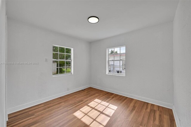 1355 NW 121st St, North Miami, FL 33167 - unfurnished room with healthy amount of natural light and wood finished floors