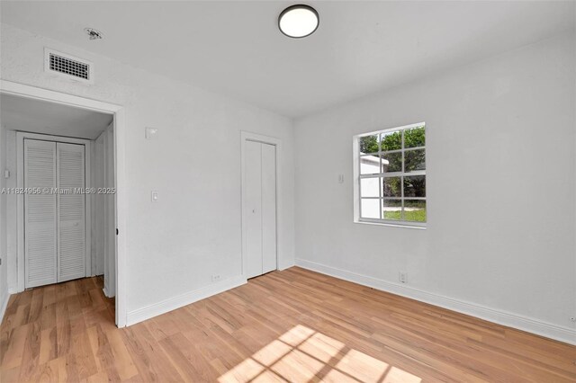 1355 NW 121st St, North Miami, FL 33167 - unfurnished bedroom with light wood-style flooring and a closet