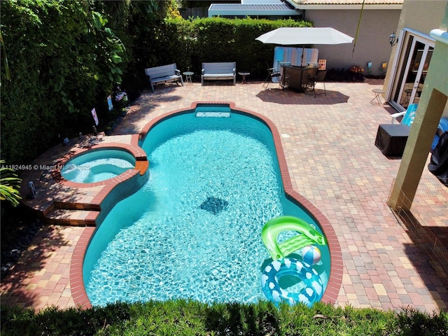 11360 NW 48th Ter, Doral, FL 33178 - view of swimming pool with a patio area and a pool with connected hot tub