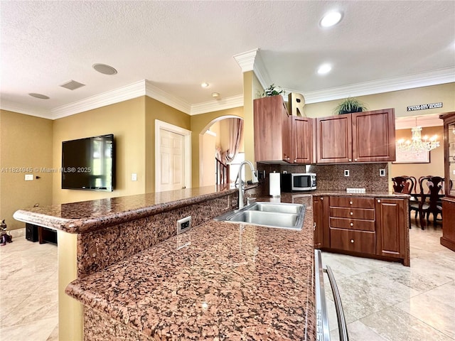 11360 NW 48th Ter, Doral, FL 33178 - kitchen with a peninsula, arched walkways, stainless steel microwave, decorative backsplash, and crown molding