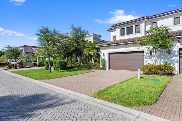 5840 E Brookfield Cir E, Hollywood, FL 33312 - mediterranean / spanish house with decorative driveway, a garage, a front yard, and stucco siding