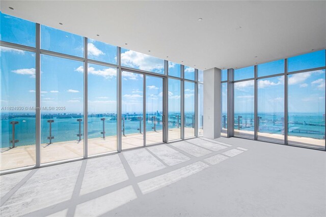 700 NE 26th Ter Unit Ph-02, Miami, FL 33137 - spare room with expansive windows and view of water and beach