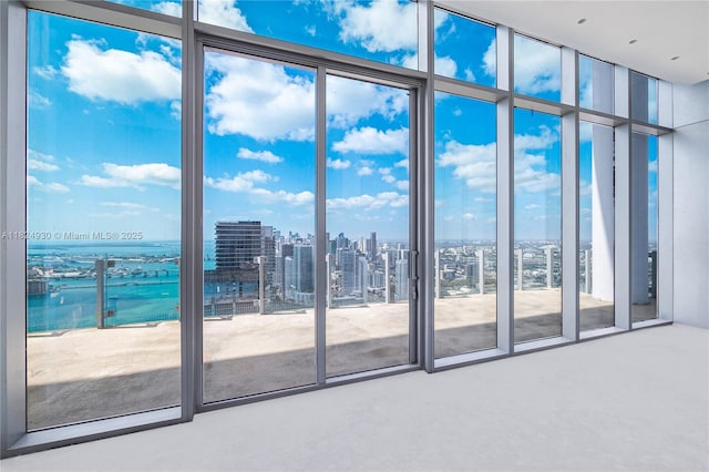 700 NE 26th Ter Unit Ph-02, Miami, FL 33137 - empty room with a water view, healthy amount of natural light, a city view, and floor to ceiling windows