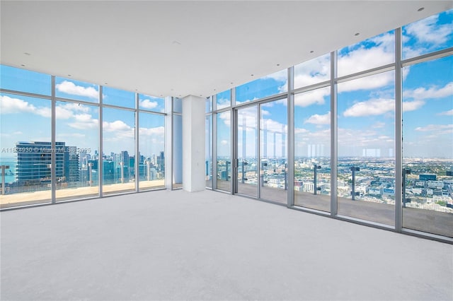 700 NE 26th Ter Unit Ph-02, Miami, FL 33137 - carpeted empty room with a wall of windows and a city view