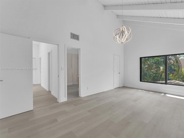 3427 Atlanta Dr, Hollywood, FL 33021 - empty room with high vaulted ceiling, a chandelier, beam ceiling, and light wood-style flooring
