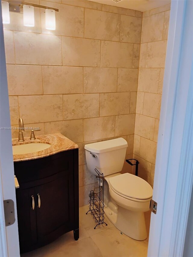 6900 Bay Dr Unit 11K, Miami Beach, FL 33141 - half bathroom with vanity and tile walls