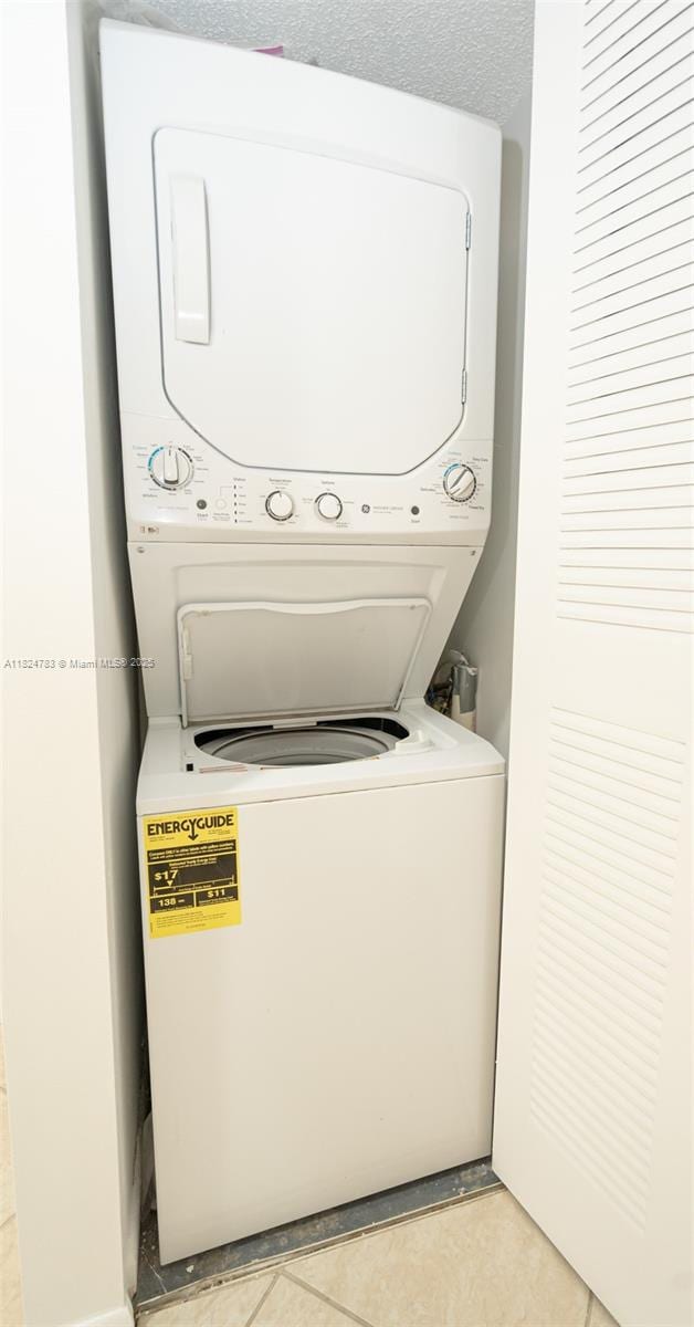 901 SW 141st Ave Unit 303M, Pembroke Pines, FL 33027 - laundry area featuring stacked washer / dryer and light tile patterned floors