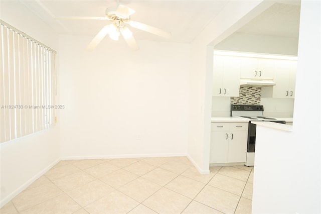 901 SW 141st Ave Unit 303M, Pembroke Pines, FL 33027 - kitchen with white range with electric cooktop, under cabinet range hood, light countertops, tasteful backsplash, and white cabinets