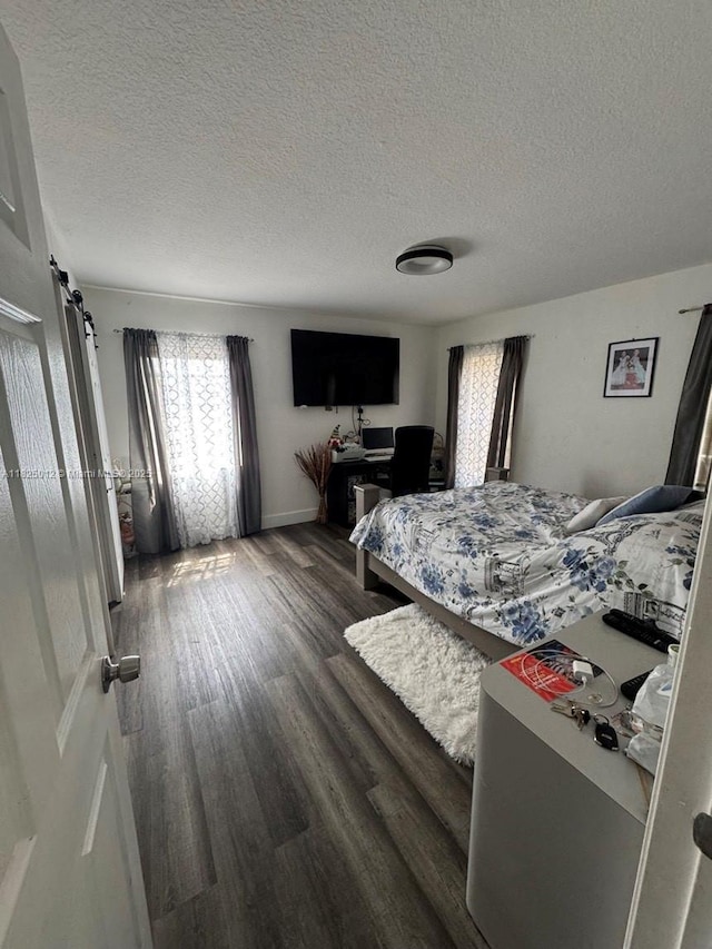 791 E 18th St, Hialeah, FL 33013 - bedroom with a textured ceiling and wood finished floors