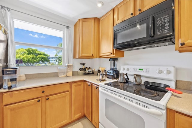 114 Royal Park Dr Unit 2B, Oakland Park, FL 33309 - kitchen featuring white range with electric cooktop and black microwave