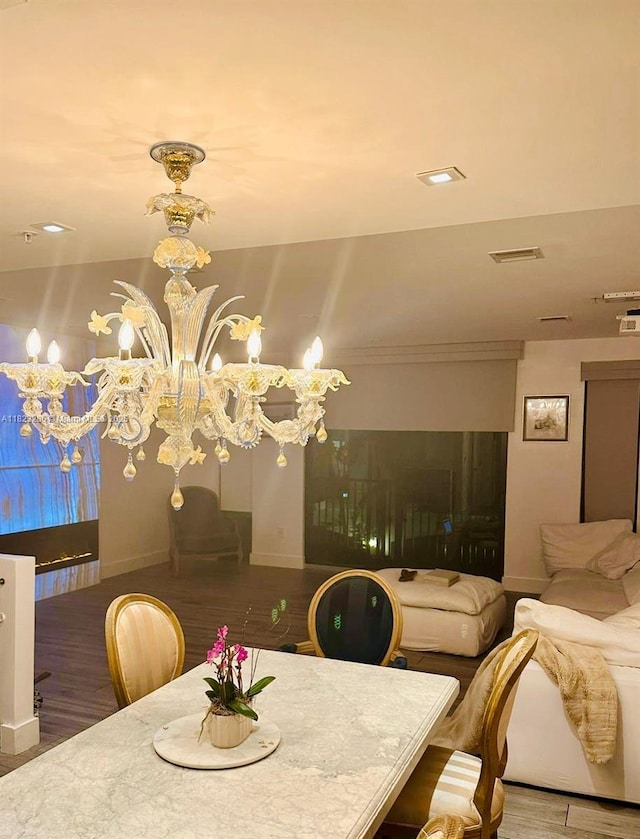 1150 98th St Unit 10, Bay Harbor Islands, FL 33154 - dining space with wood finished floors and a chandelier