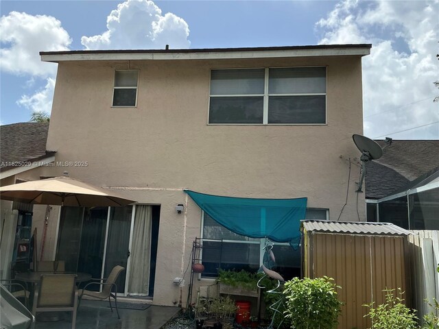4925 W Lakes Dr, Deerfield Beach, FL 33442 - back of property featuring stucco siding and a patio